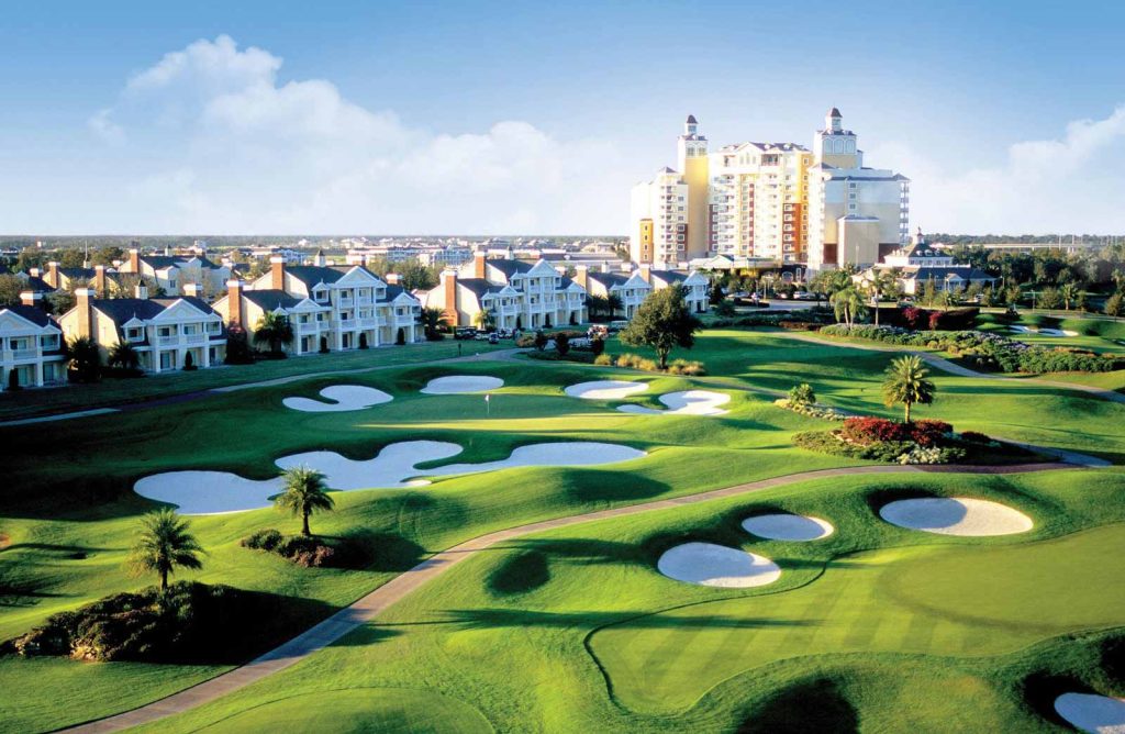 A birds-eye image of Reunion Resort in Reunion, Florida, taken from across the golf course including the Grand Hotel in the distance.